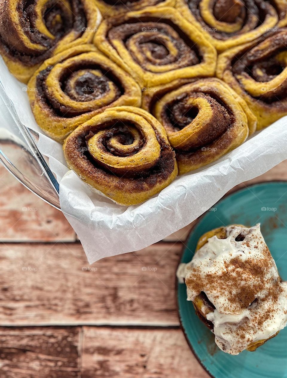 Homemade pumpkin cinnamon rolls, frosting cinnamon rolls, maple syrup cream cheese frosting on homemade pumpkin cinnamon rolls, baking from scratch, beautiful baked goods 