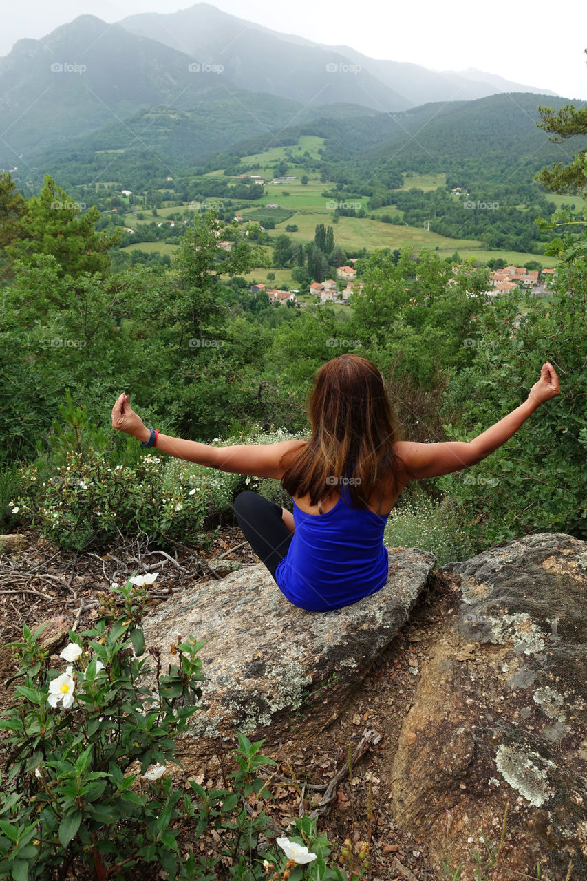 Woman meditating in summer on the mountain 