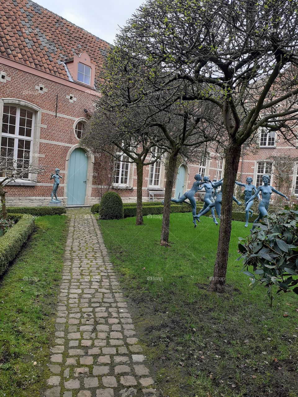 statues in a garden of an old house in Mechelen Belgium
