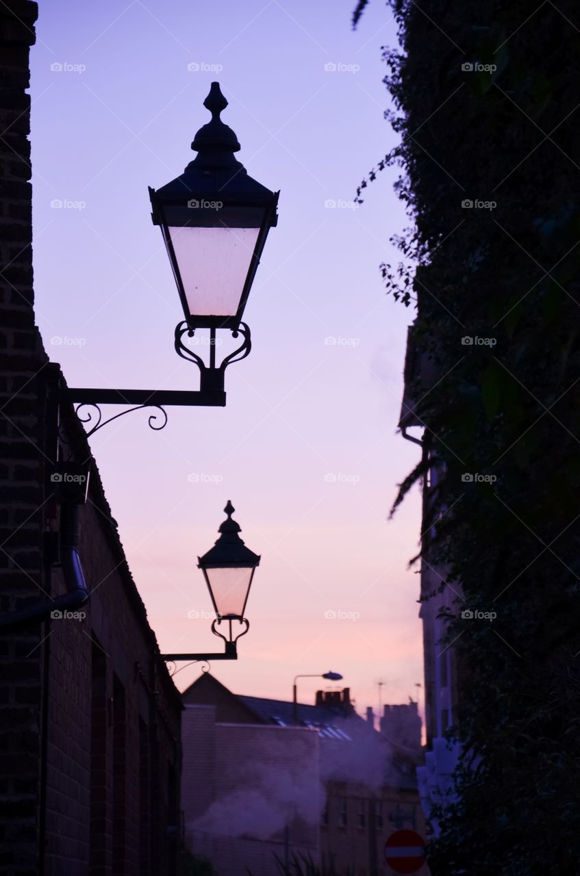 Low angle view of street light against dramatic sky