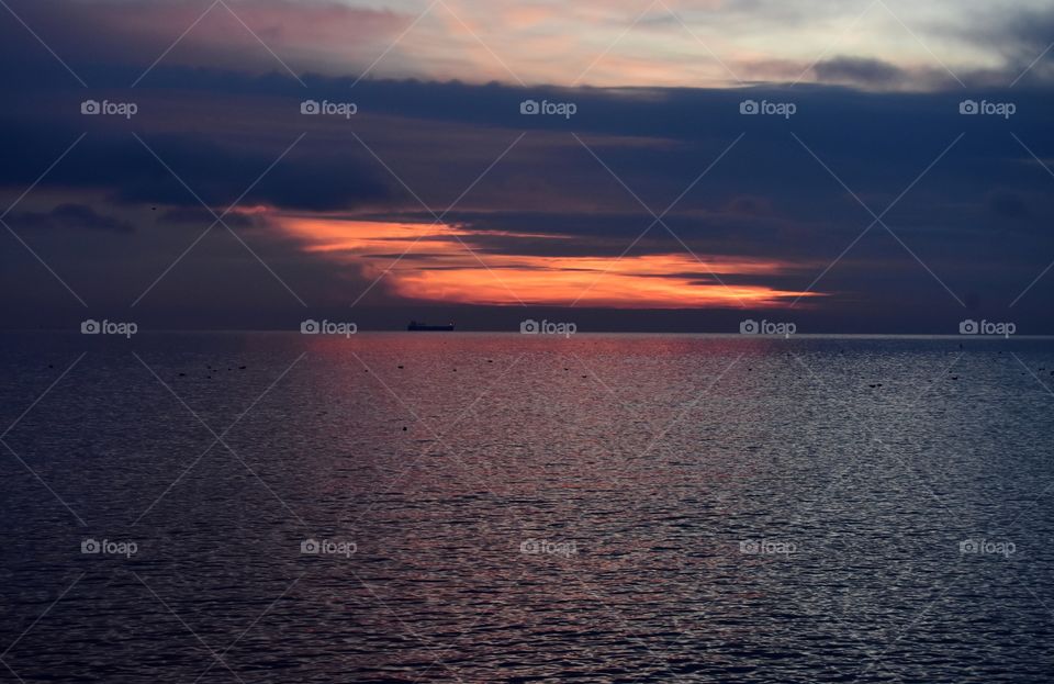 Gold cloudy sunrise over the baltic sea in gdynia, poland