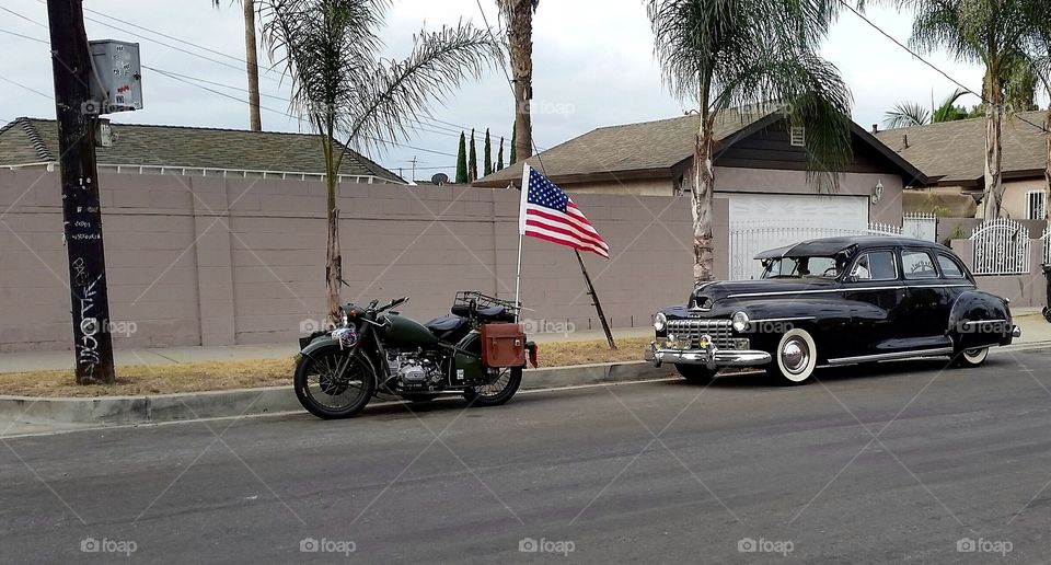 Harley and low rider American . Neighbors house
