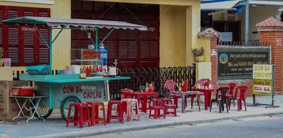 Empty chairs waiting for street food customers in Hoi An