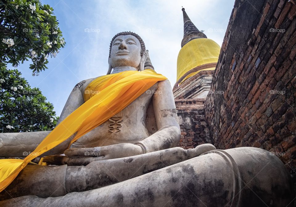 The sun halo over Wat Yai Chimongkol formerly named "Wat Pa Keaw" or "Wat Chao Thai" Located at Aytthaya Thailand. Highlights of the Temple is the big Pagoda is located on the East side of Ayutthaya.