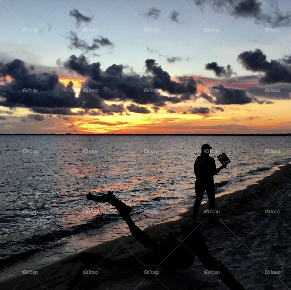 Sunset under heavy black clouds