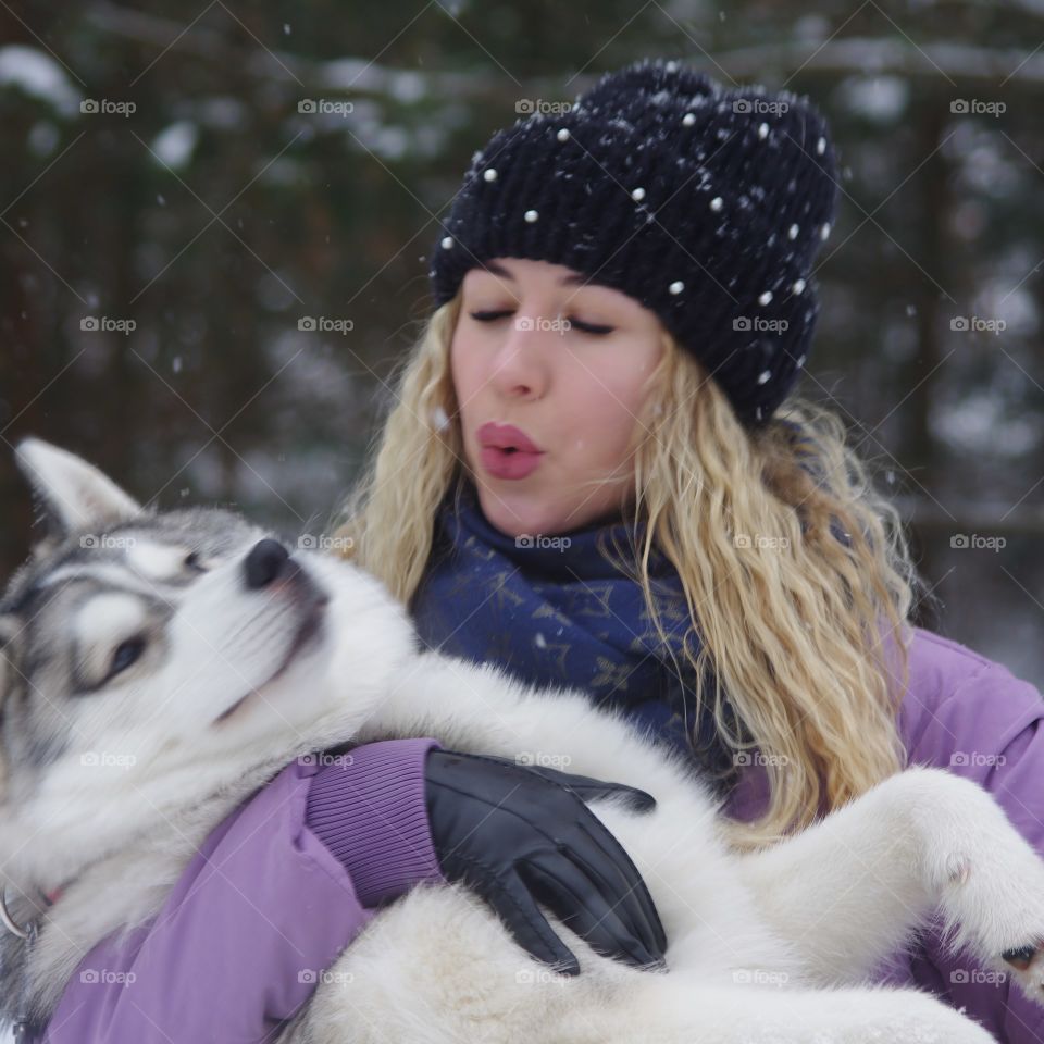 girl holding a dog breed Husky