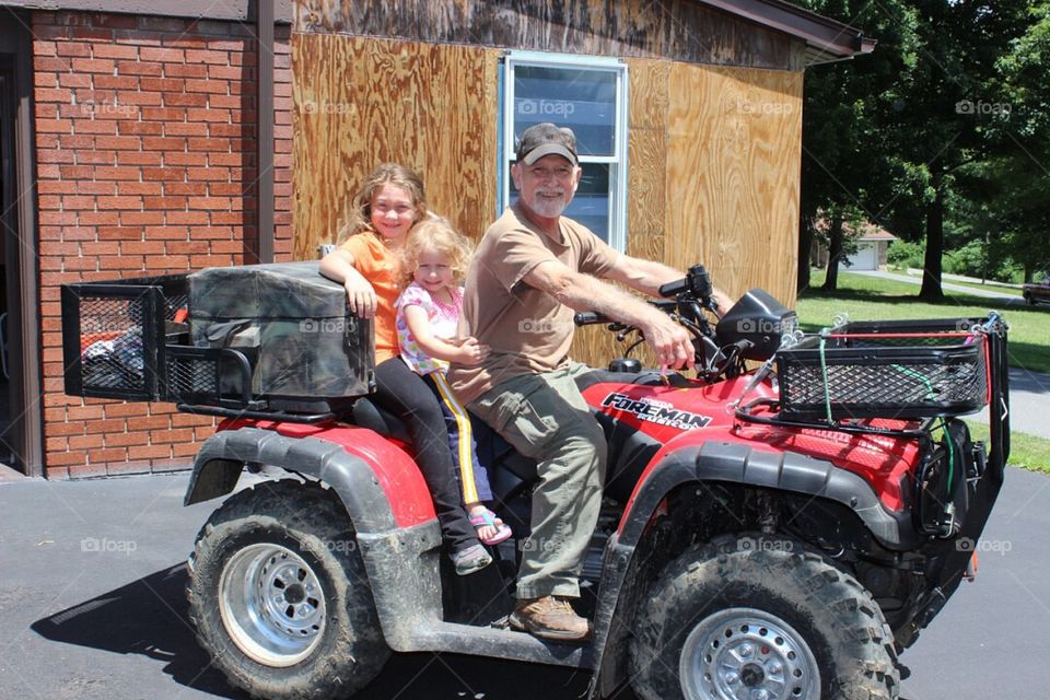 Father and daughters on vehicle