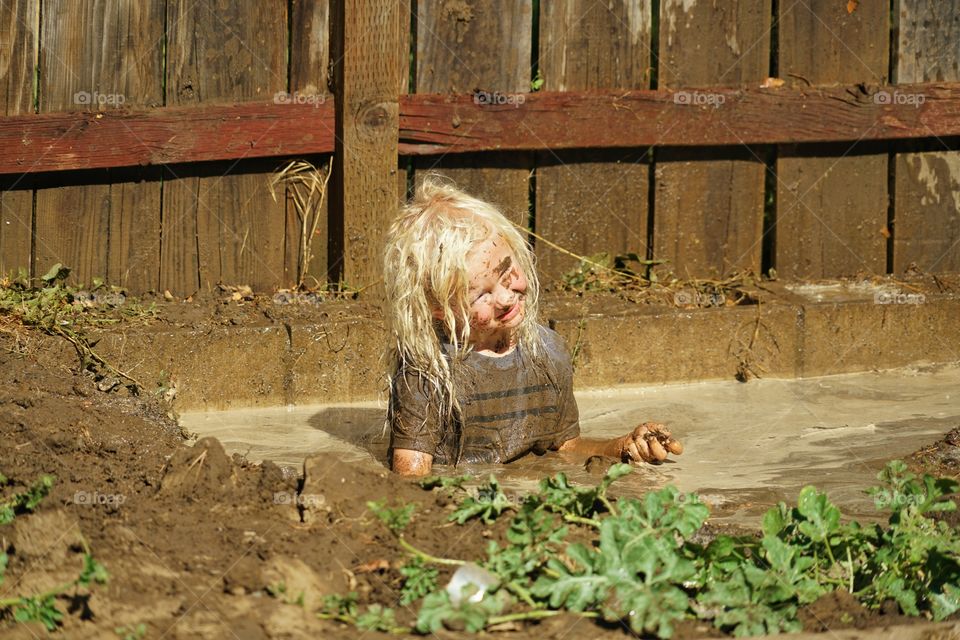 Boy Playing In The Mud