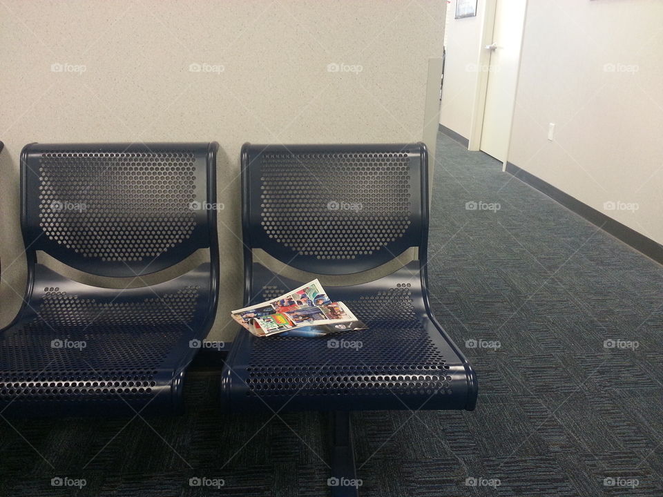 Blue waiting room chairs with flyers