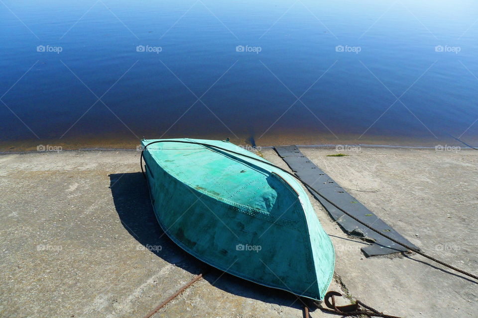 inverted boat on a concrete embankment