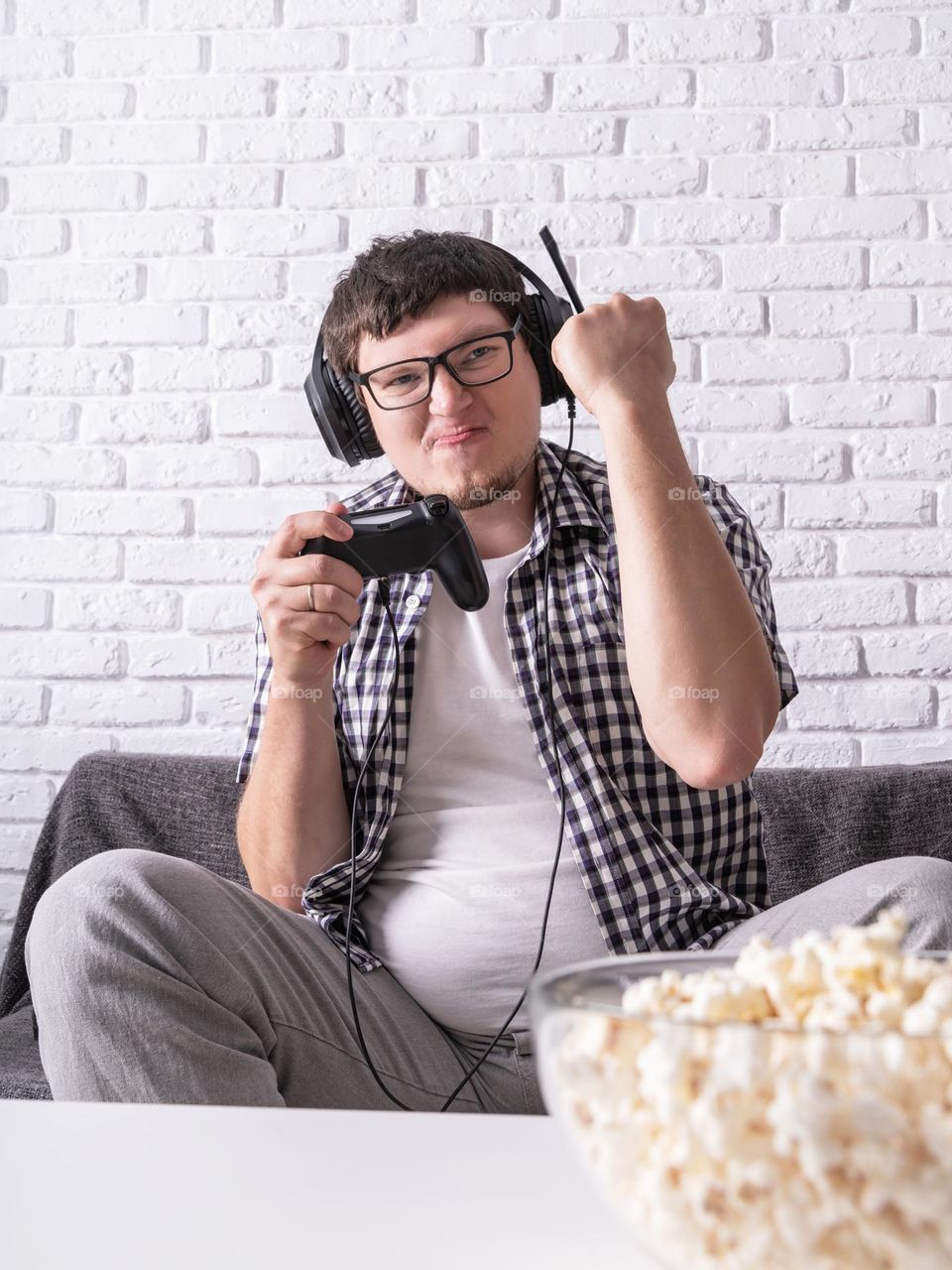 young emotional man playing video games