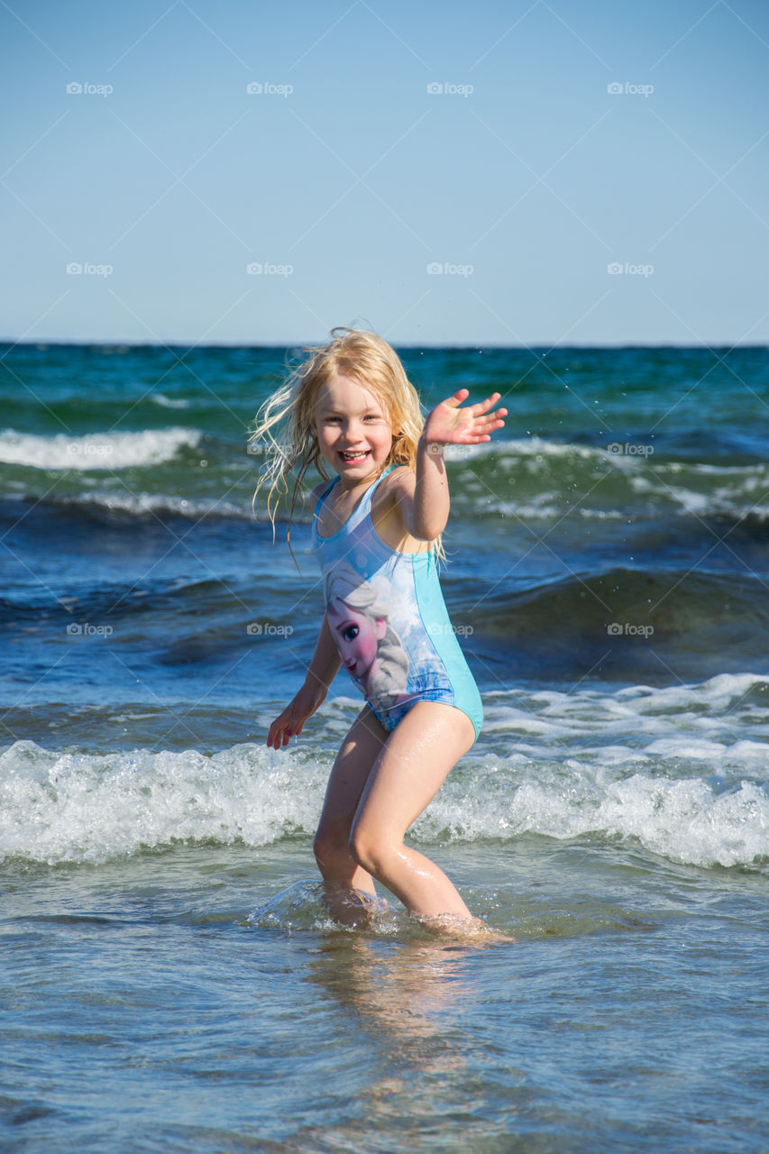 Portrait of cute girl enjoying at beach