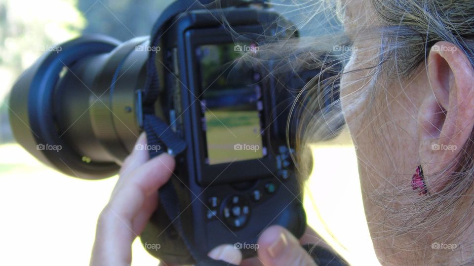 Closeup of videographer camera center frame with live view in monitor