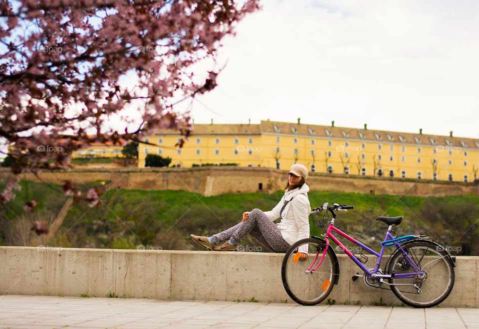 woman and her bike. woman resting with her bike aside