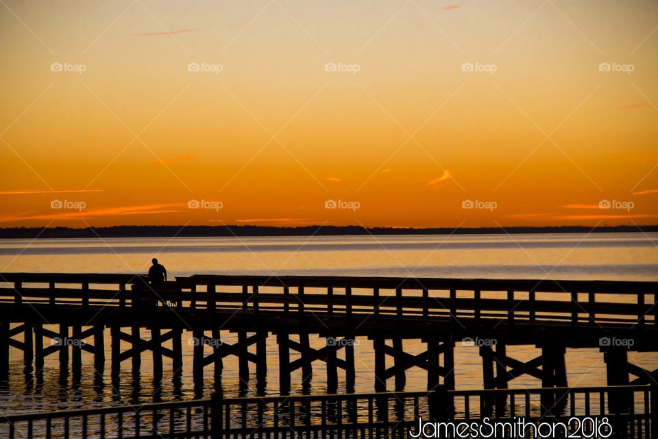 A sunset shot of a peir on the James River, taken in Hilton Village, Hampton Roads, VA.