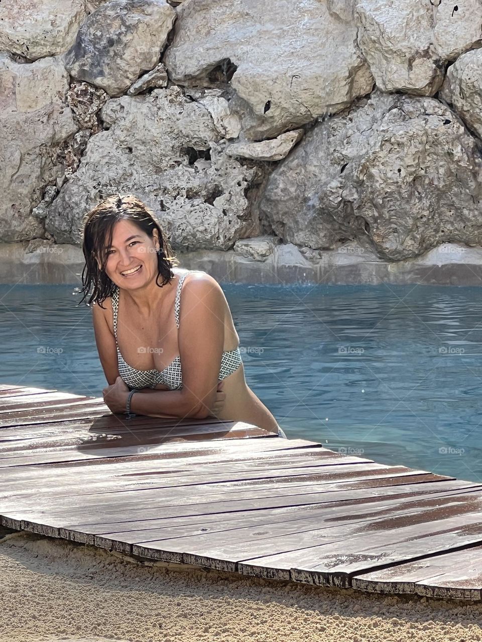 Woman smiling in swimming pool 