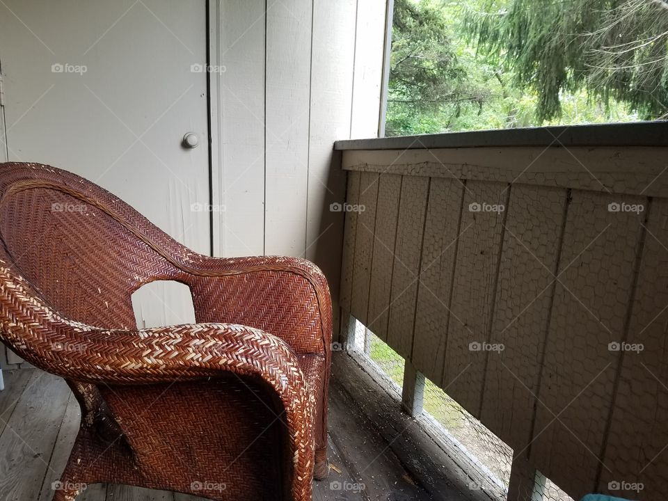 Old wicker chair on my back porch
