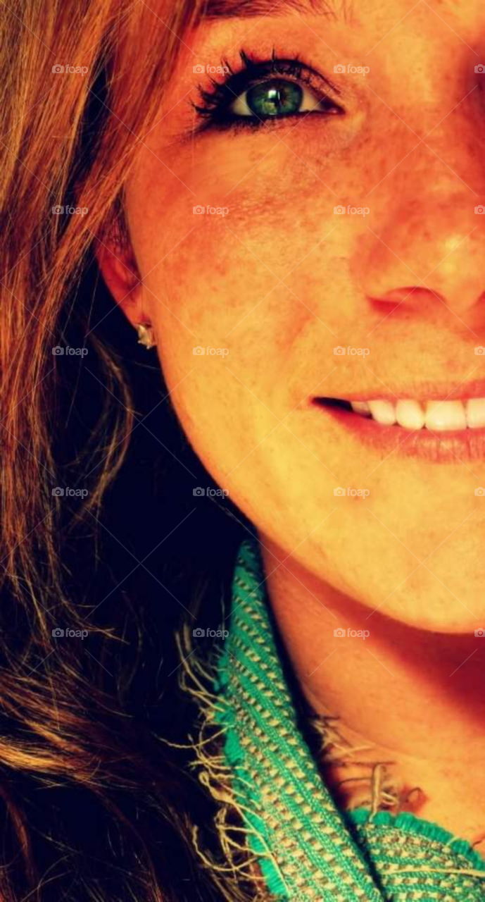 Woman with freckles and green eyes close up