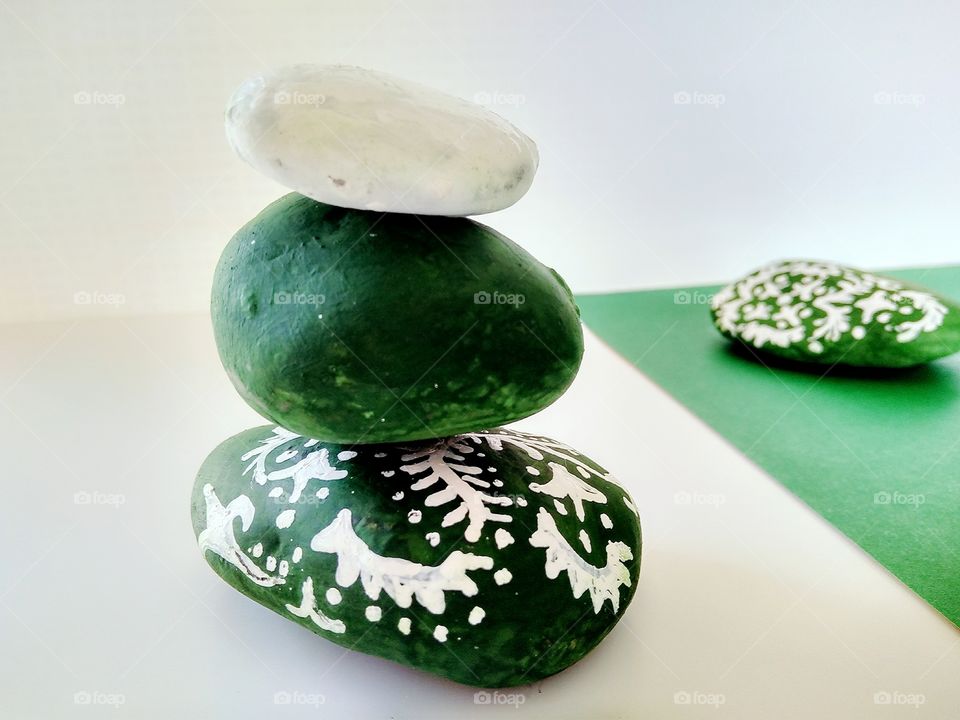 White x green by foaр missions,stones painted with green and white paints covered with painting