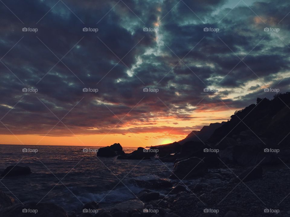 Sunset and dark sky at the sea 