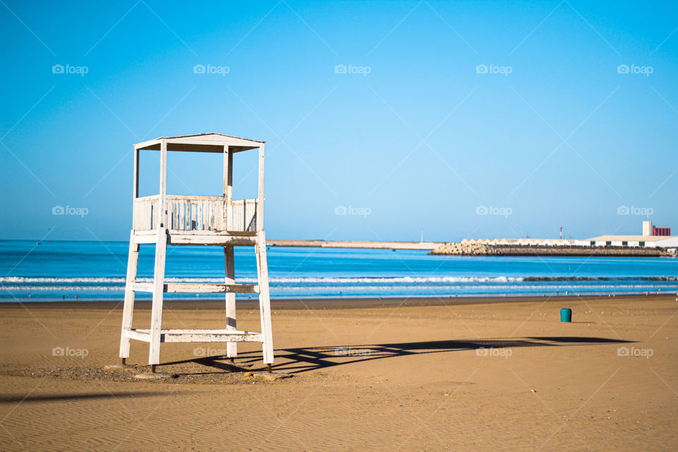 Beach lifeguard security tower bungalow in an empty beach with no people