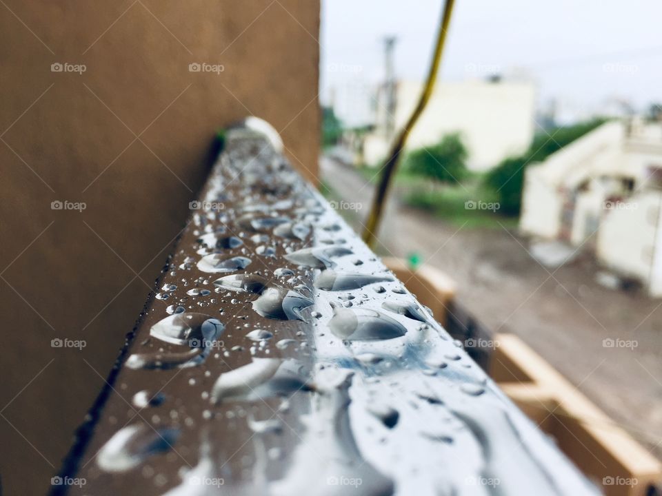 Steel rectangle pipe filled with water drops of rain 