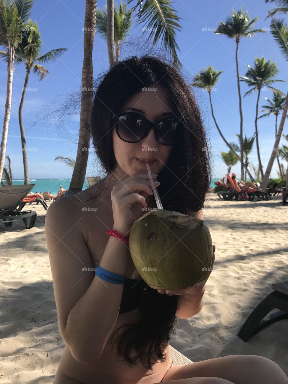 Beautiful girl with coconut.Ocean 