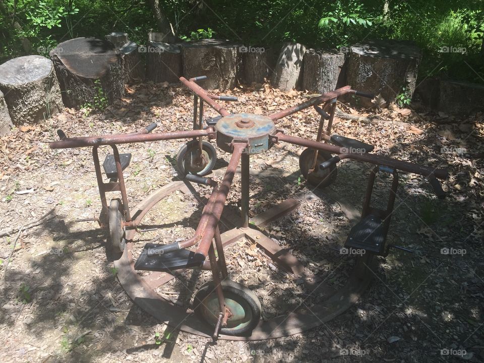 Old children’s rusted playground bicycle ride.