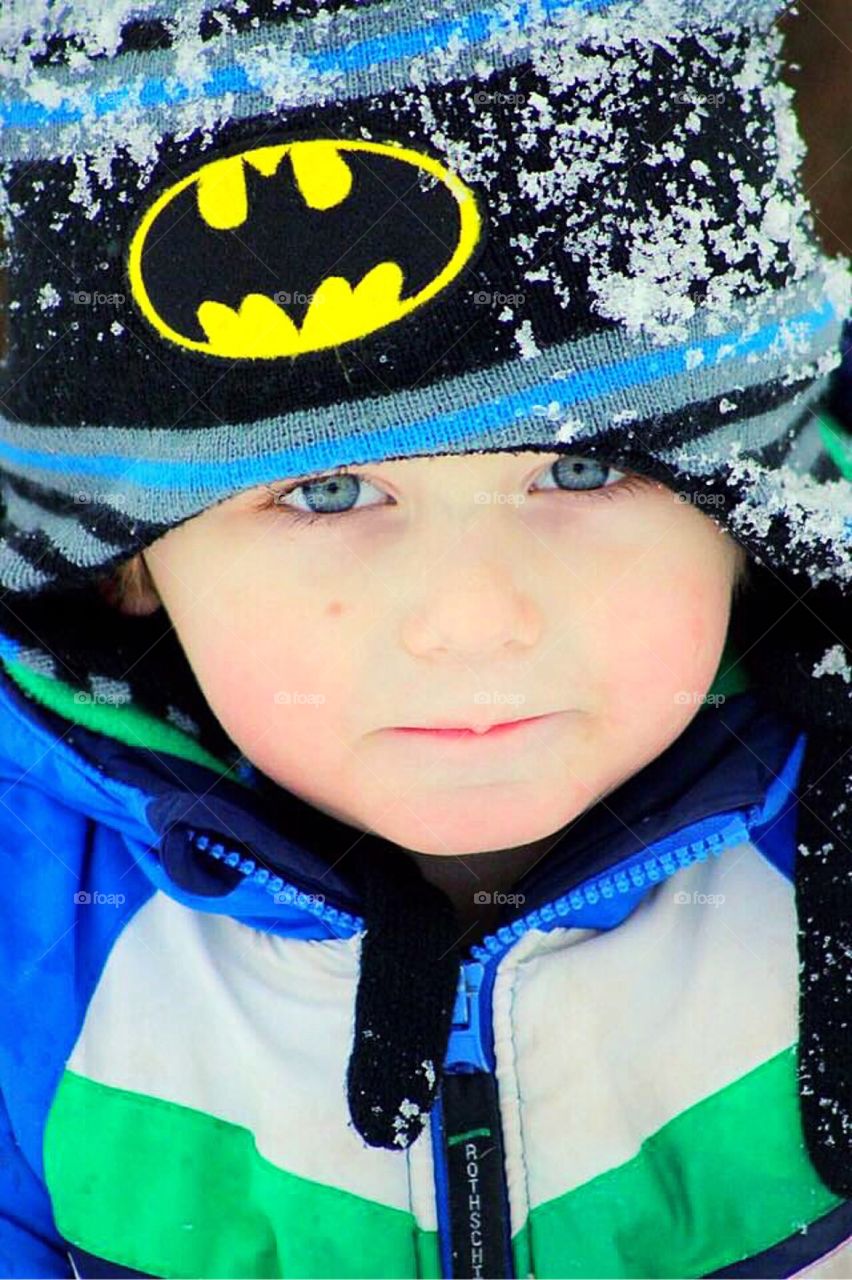 The icy blue hue of this adorable toddlers eyes perfectly match the signs of winter blustering around him. 