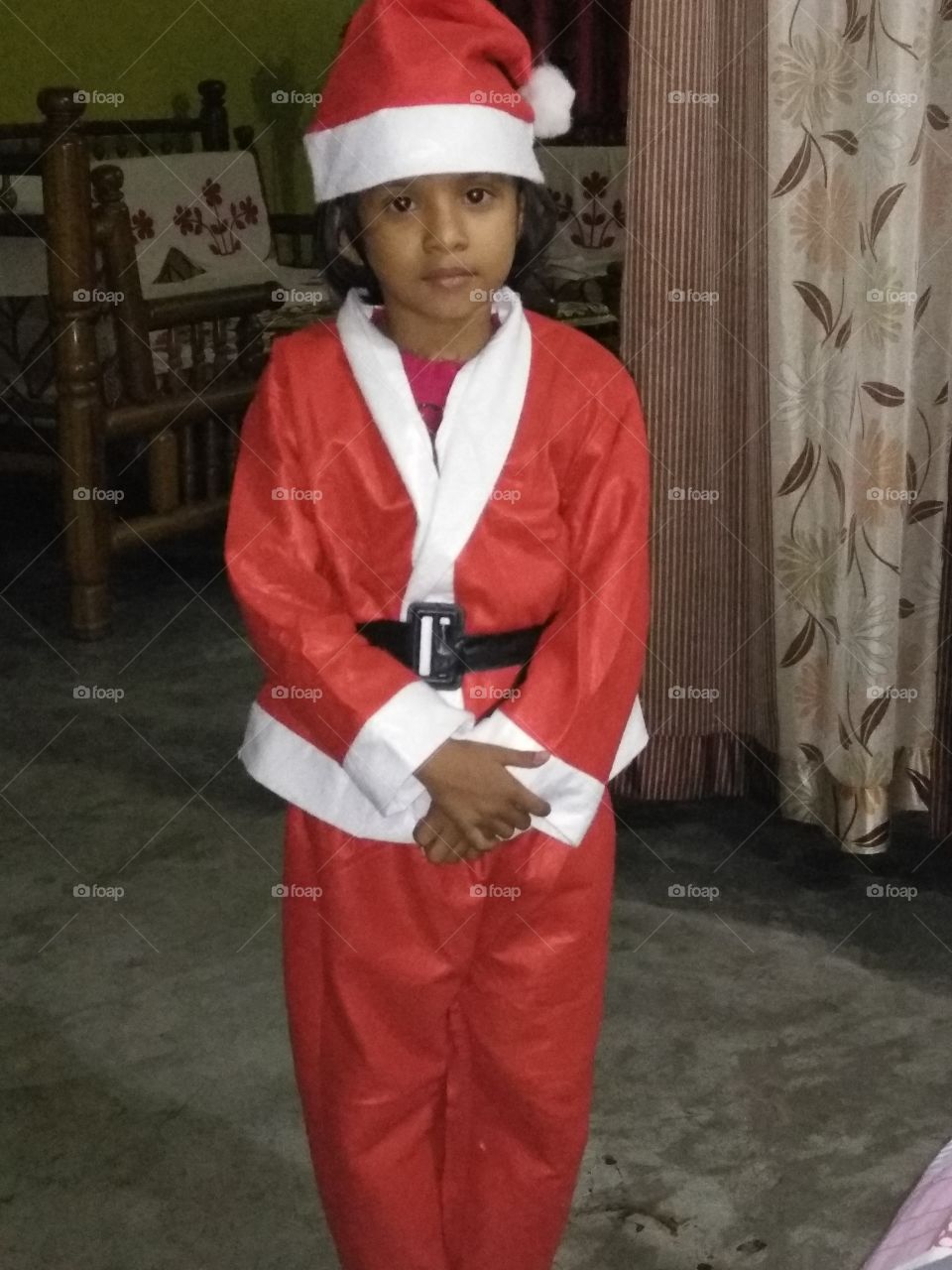 Little girl undisguised as Santa Claus