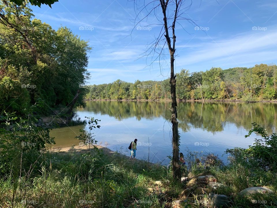 North Michigan In The Forest By The River With Forest Reflection On The Water Enjoying A Nice and Sunny Day!