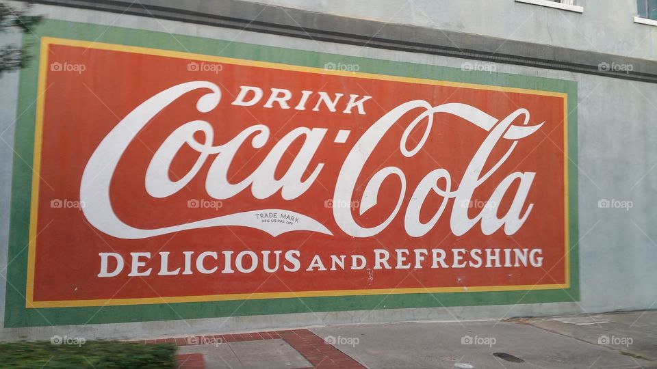 coca-cola. coca-cola sign in a wall