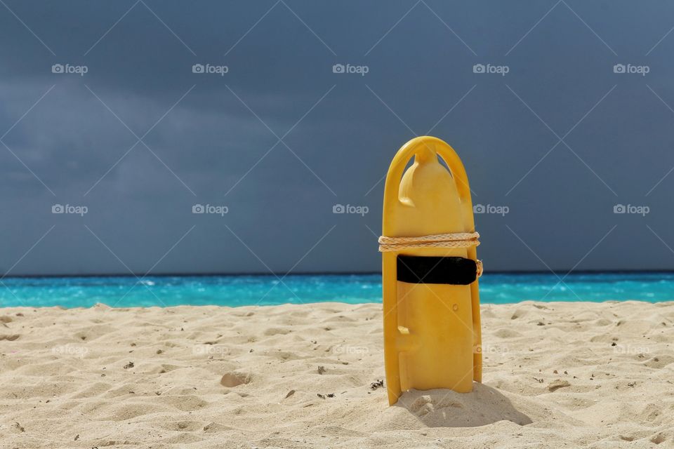 lifebelt in the beach with sthorm in the horizon