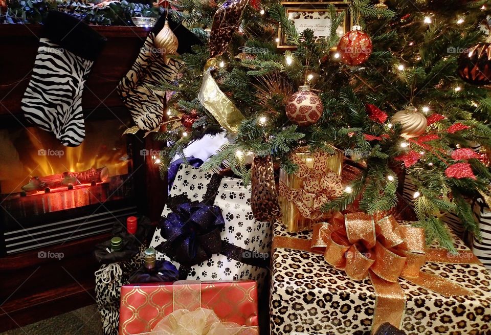 Wrapped presents beneath a beautifully decorated Christmas tree for the holiday season. 