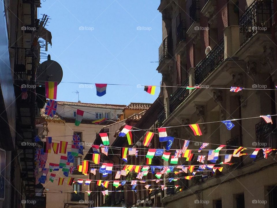 Different flags hanging on top of the houses