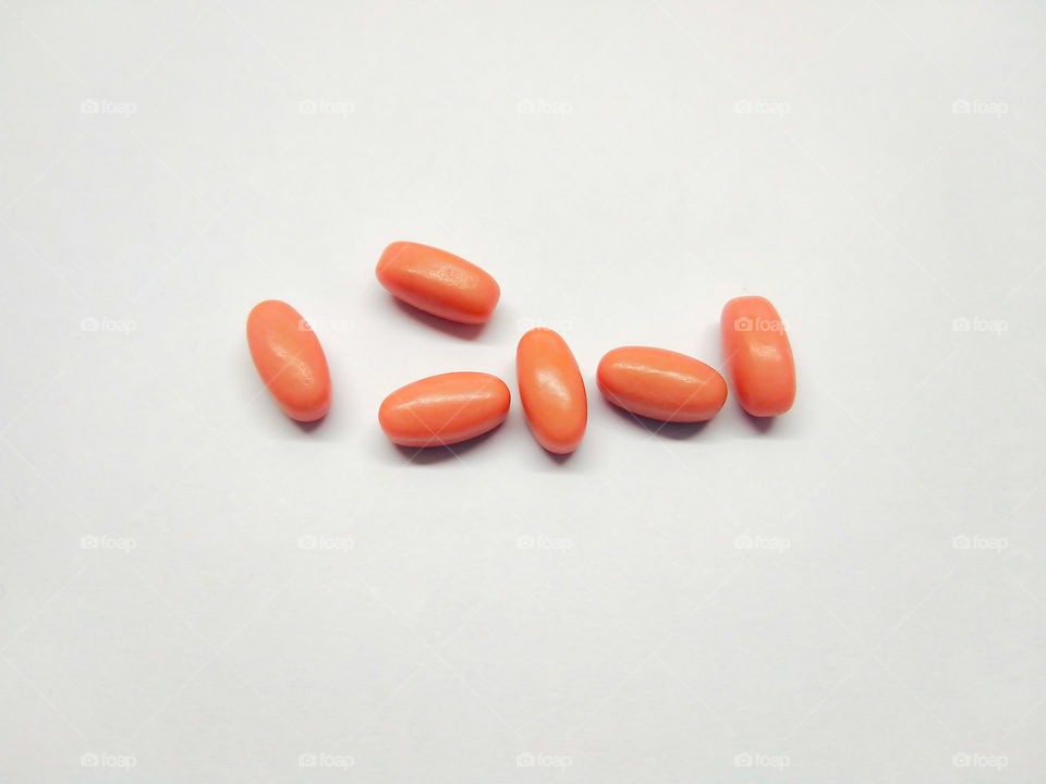 Red​ pills.​ Drug on​ White​ background