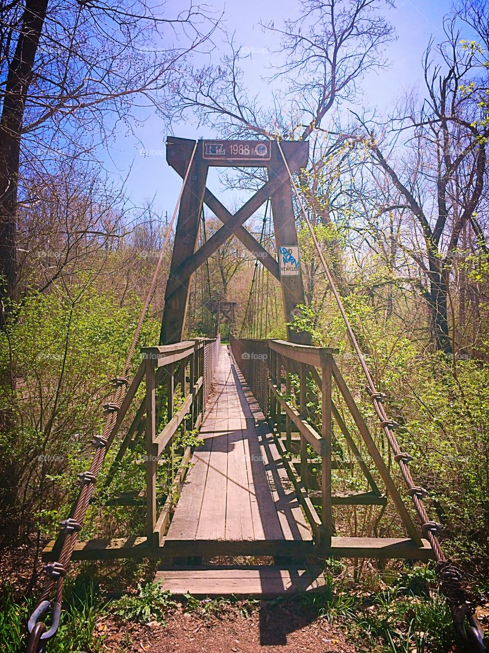 Swinging bridge . Wooden swinging bridge entrance 