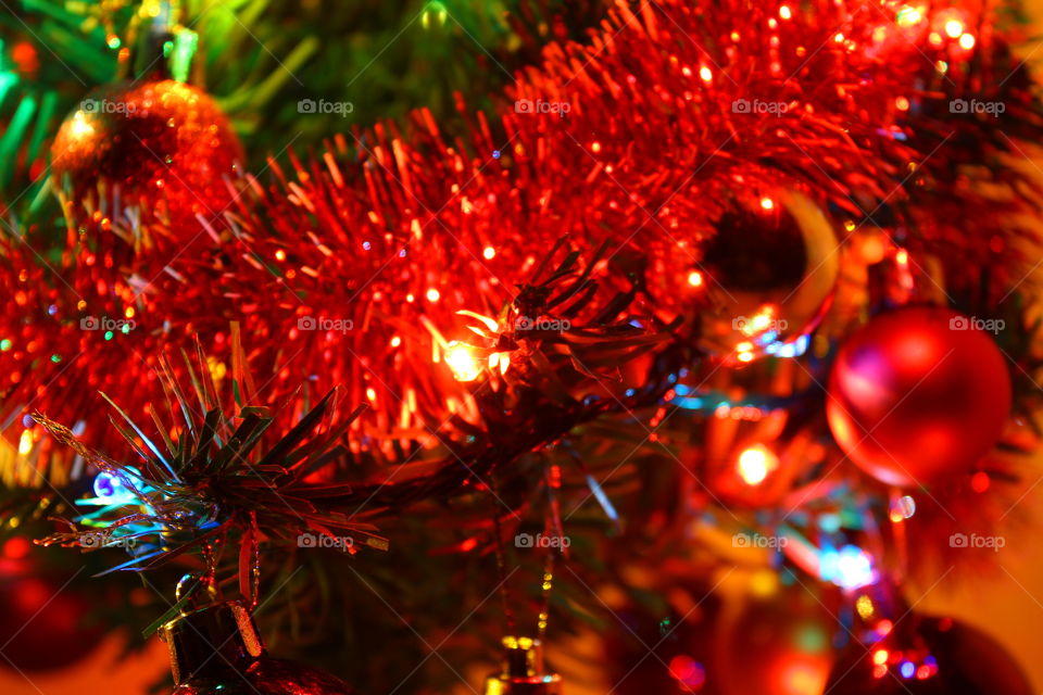 Macro shot of Christmas tree decorations and vivid lights