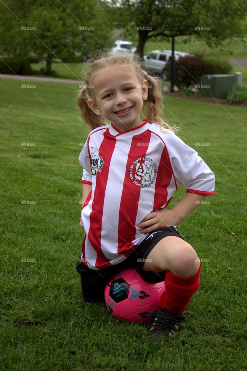 Smiling girl with football