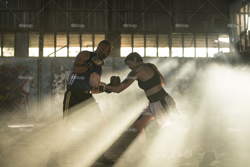 Boxers in smokey warehouse 