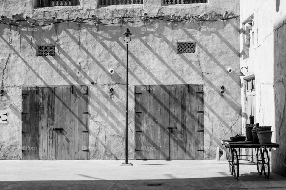 An old wall with diagonal shadows at the traditional market