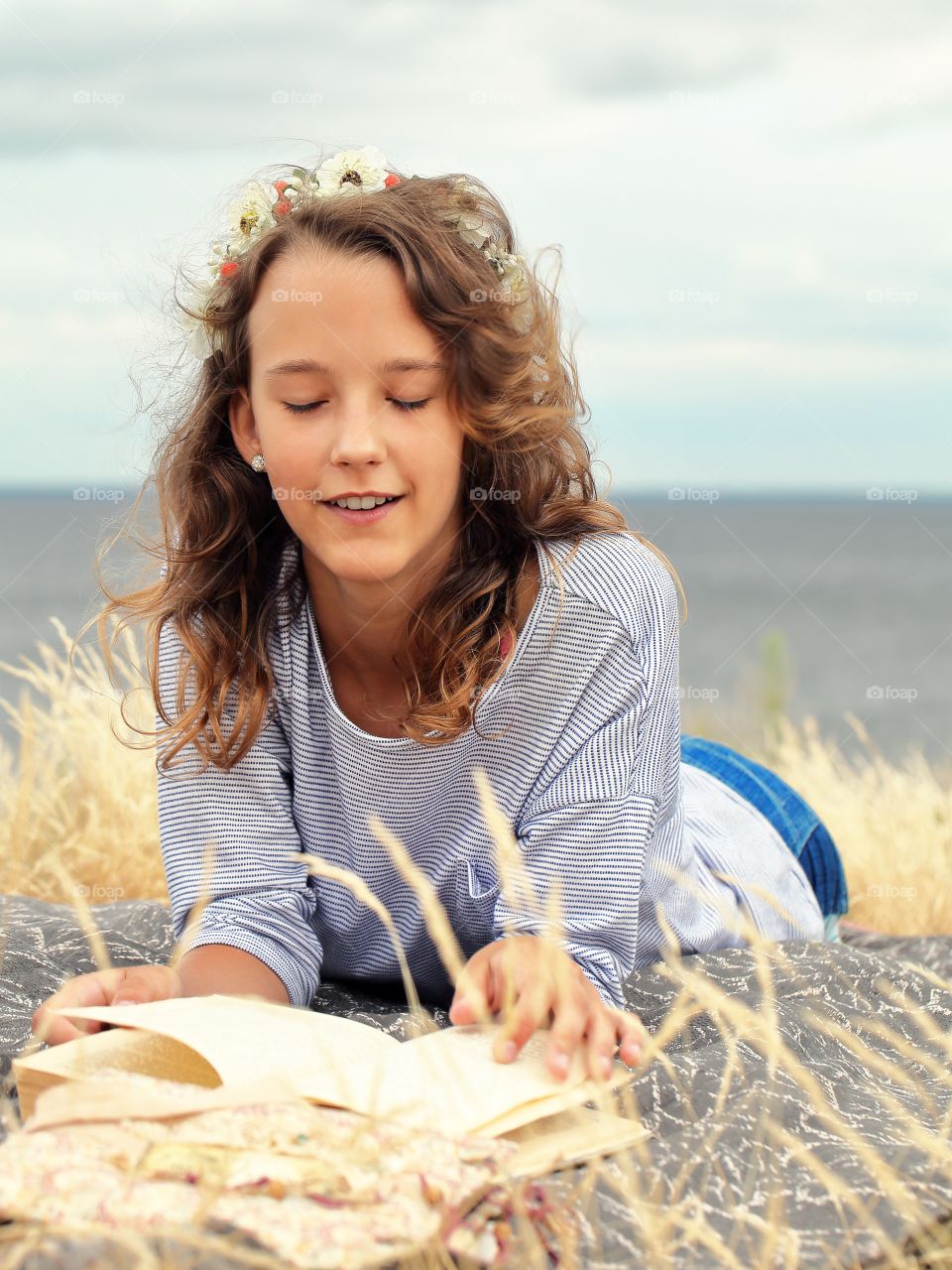 Curly-haired girl reading a book 