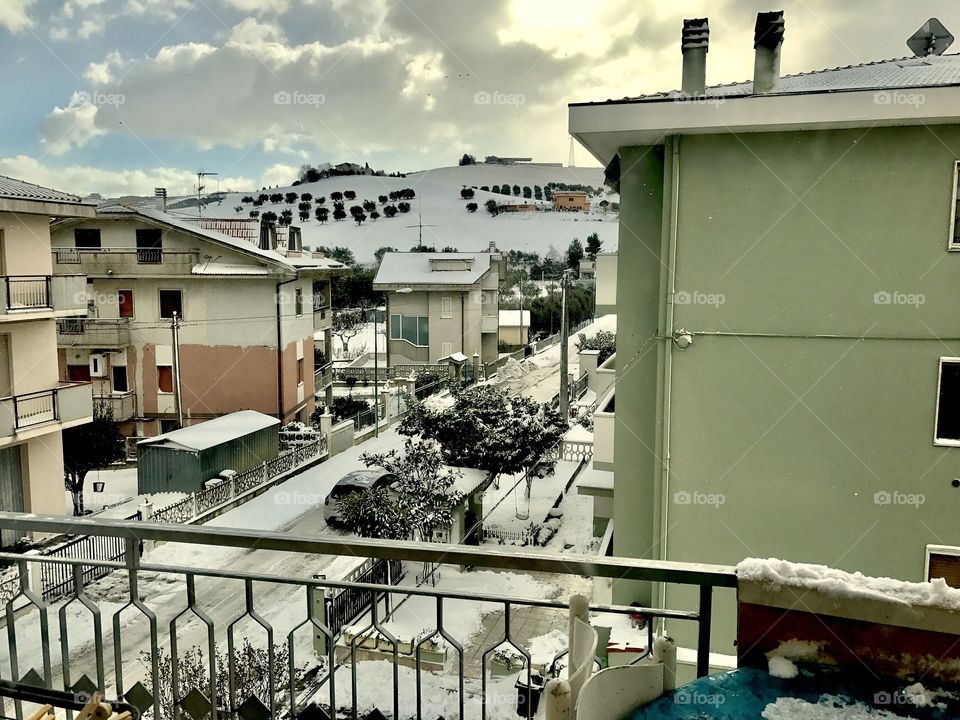 Snowy landscape, town, balcony view 