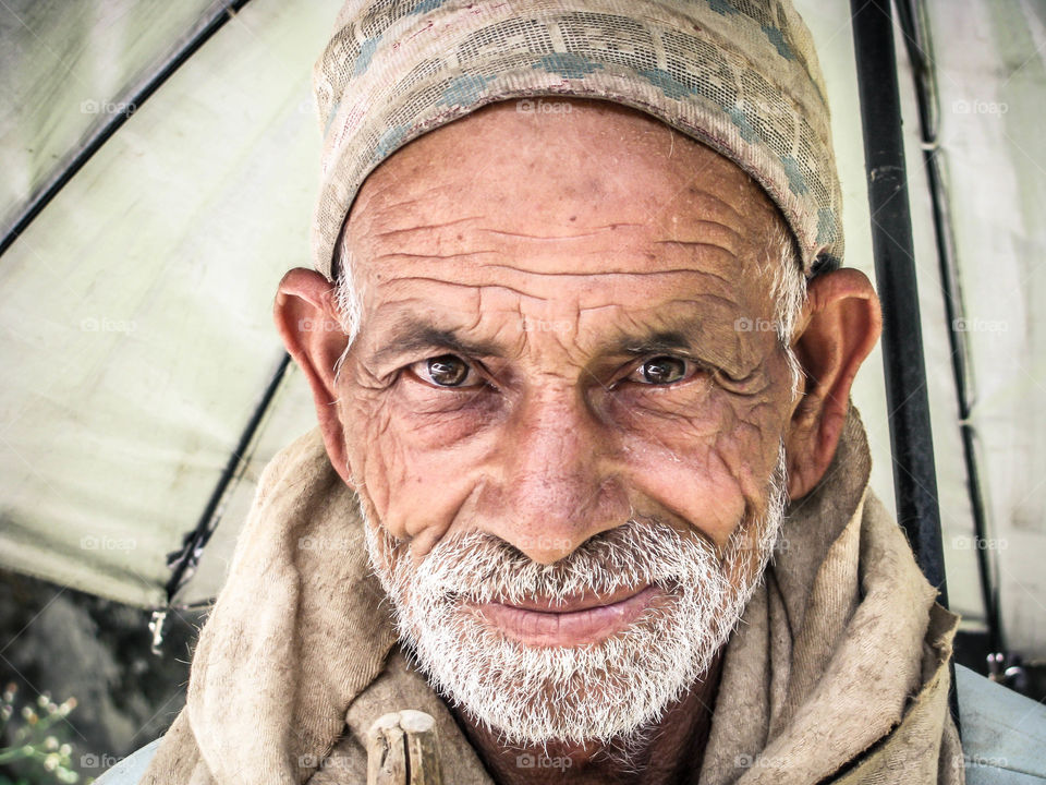 Senior Asian beard man looking at camera