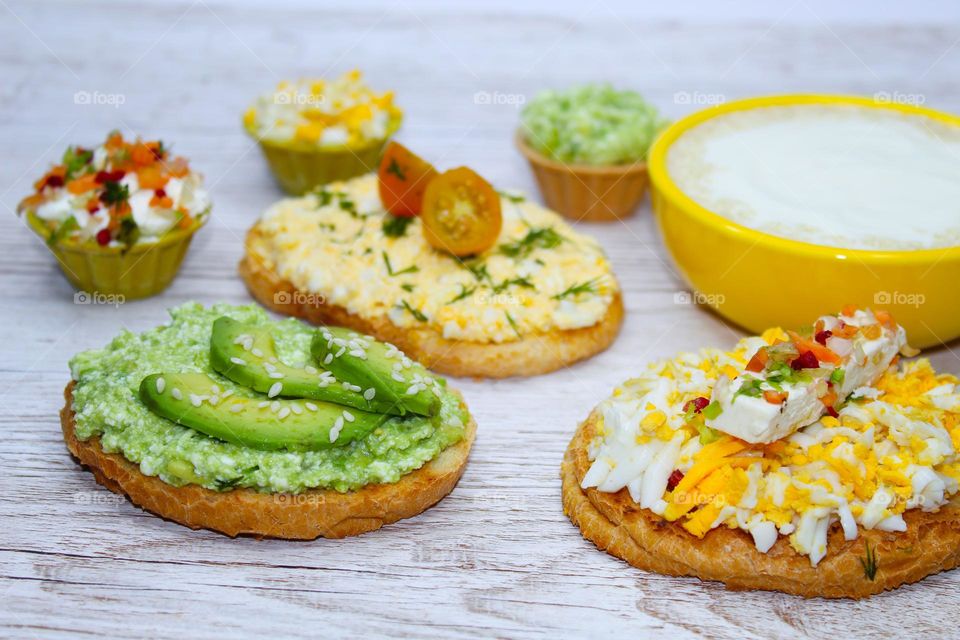 Vegetarian breakfast : bread with a spread of boiled eggs, avocado and cheese