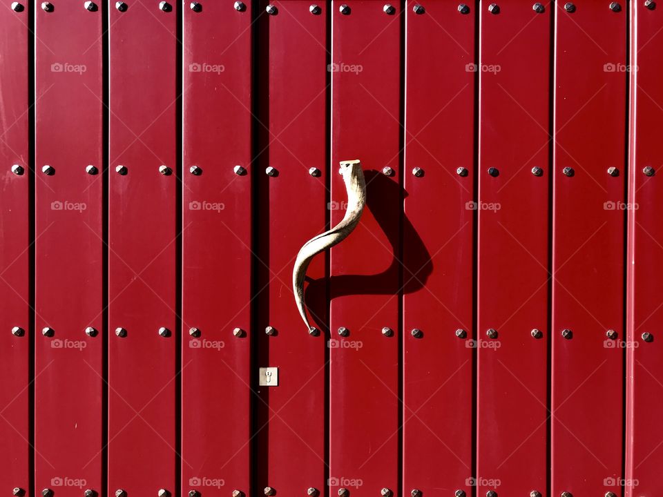 Shadow on an old red door 