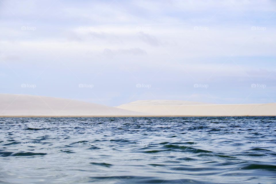 Lençóis Maranhenses National Park, Maranhão, Brazil. A vast area of undulating, swept sand dunes between which rainwater lakes form at certain times of the year. The result is midnight blue lakes offset by brilliant white dunes