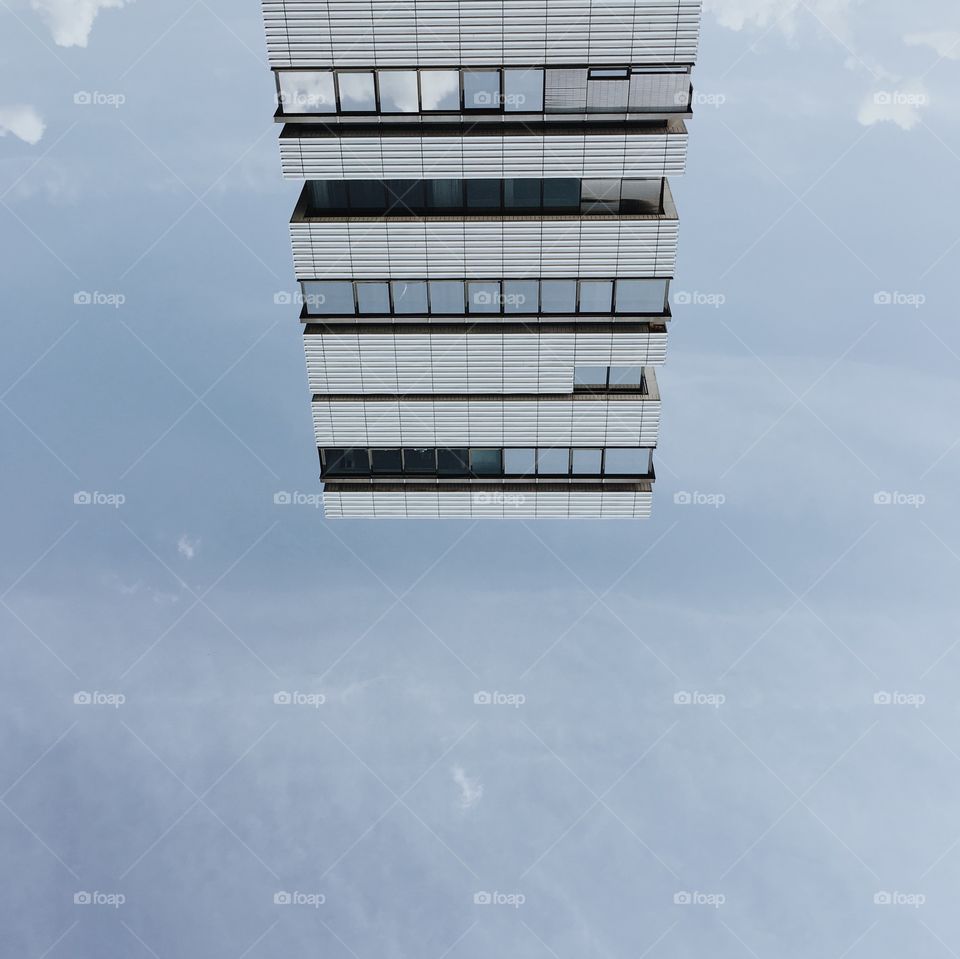 Bottom down modern skyscraper on blue sky
