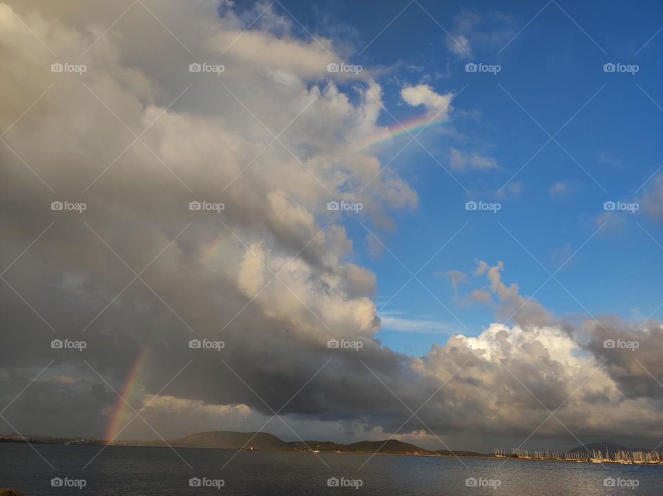 Rainbow after rain over the sea