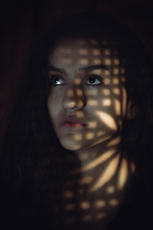 Photograph of girl, with shadow caused by a window